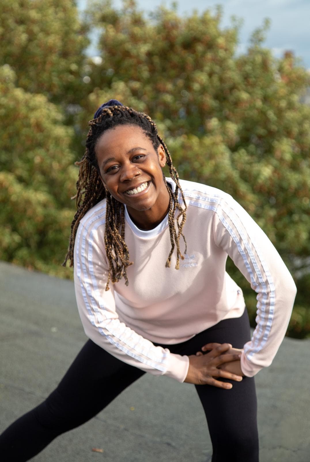 Personal Fitness Coach Esther Nyerembe aus Hamburg bei einer seitlichen Dehnung mit gestrecktem Arm
